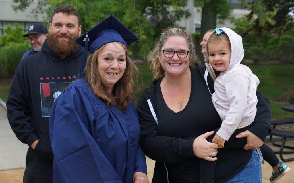 Family posing together at graduation ceremony